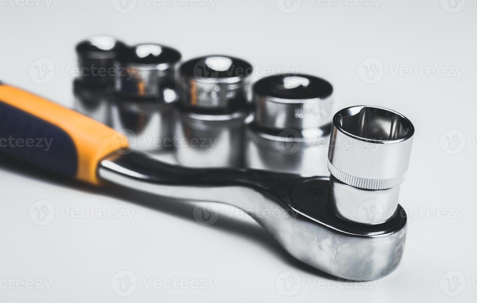 Wrench set with socket attachments arranged neatly on a white surface for clear visibility and easy access photo