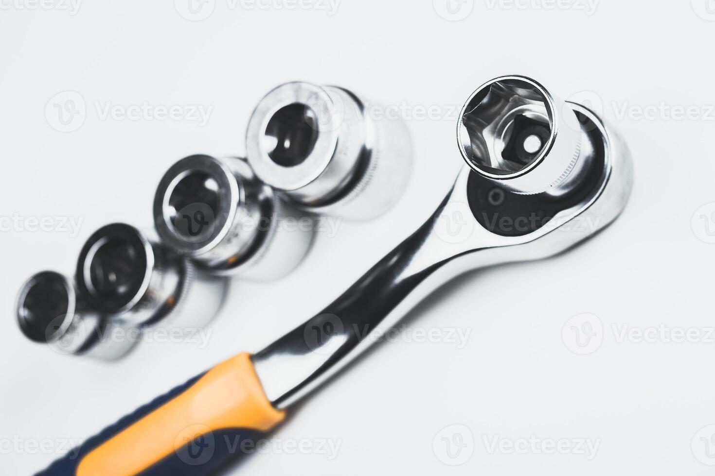 Socket wrench set displayed on a white surface with multiple attachments for versatile tasks photo