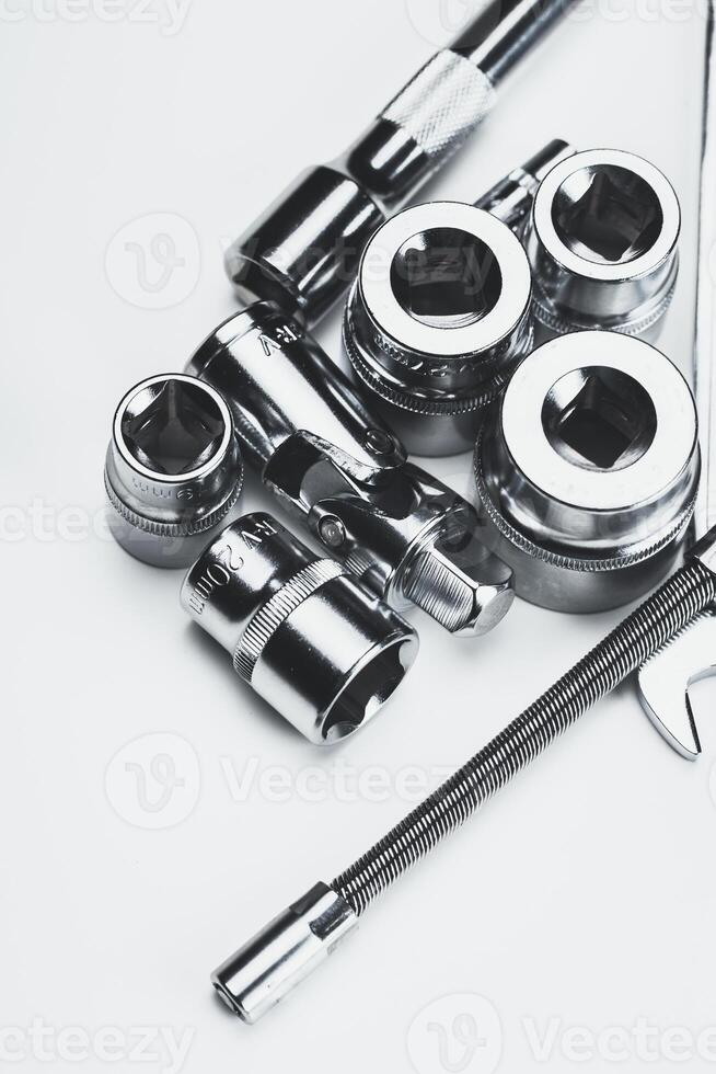 Collection of various metallic tools arranged on a flat surface showcasing their intricate details and designs for mechanical work photo