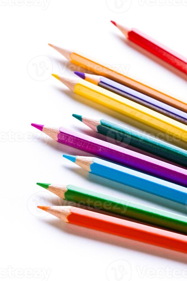 Colorful assortment of sharpened pencils arranged in a line creating a vibrant display on a white background photo