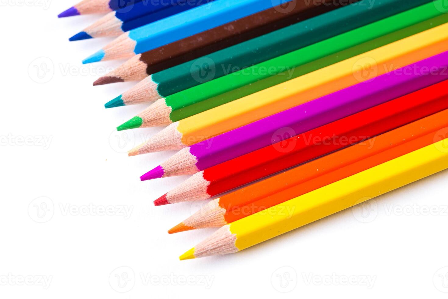 Colorful collection of sharpened pencils arranged in vibrant order on a white background photo