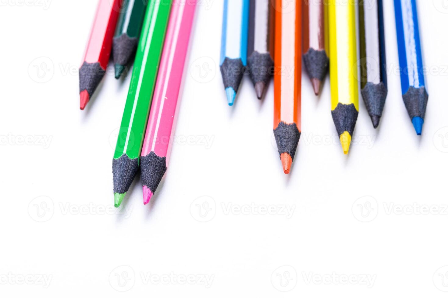Collection of colorful pencils arranged neatly on a white background for art projects and creative activities photo