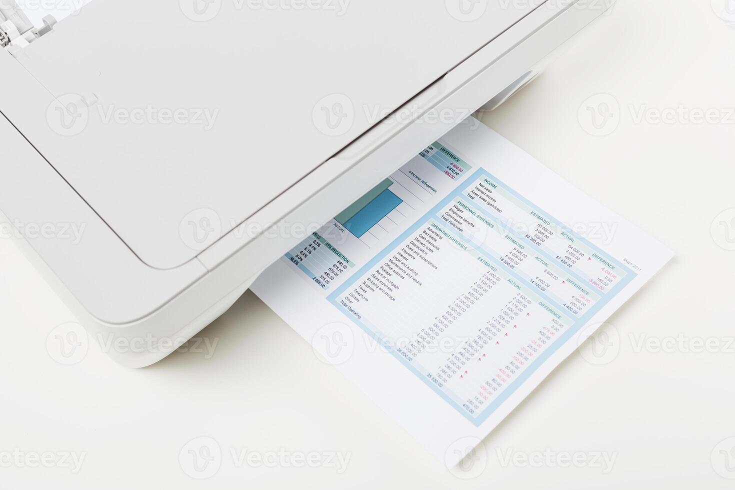 Printer working on a document with financial data in a home office on a bright afternoon photo