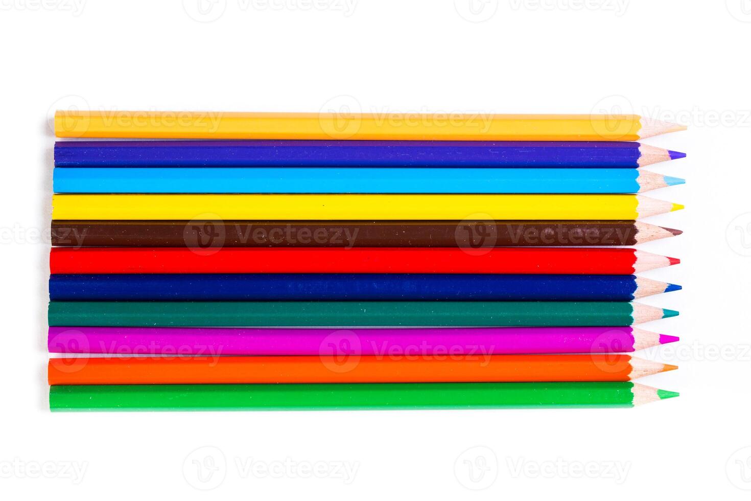 Colorful assortment of art pencils arranged in a row on a clean white background providing inspiration for creative projects photo