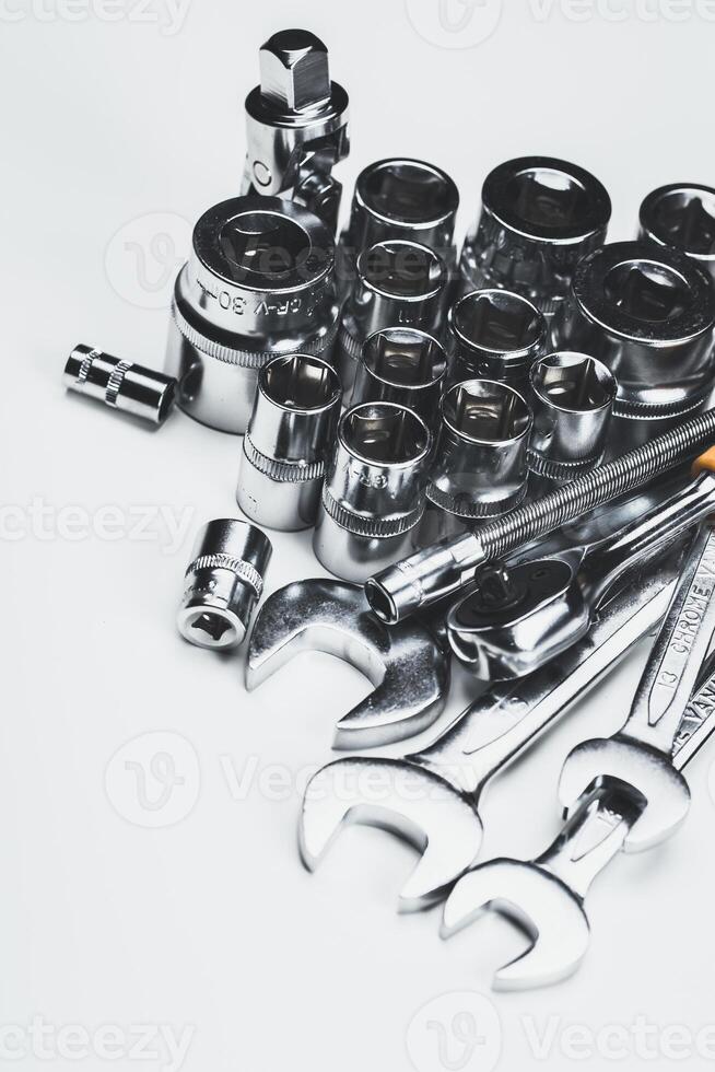 Tools arranged neatly on a white surface ready for a mechanical repair task in a workshop setting photo