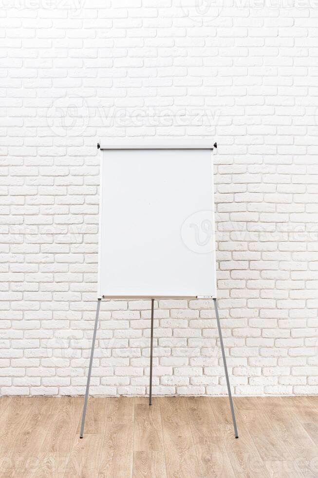 Blank flip chart in a bright meeting room ready for brainstorming and collaboration session in a modern office environment photo