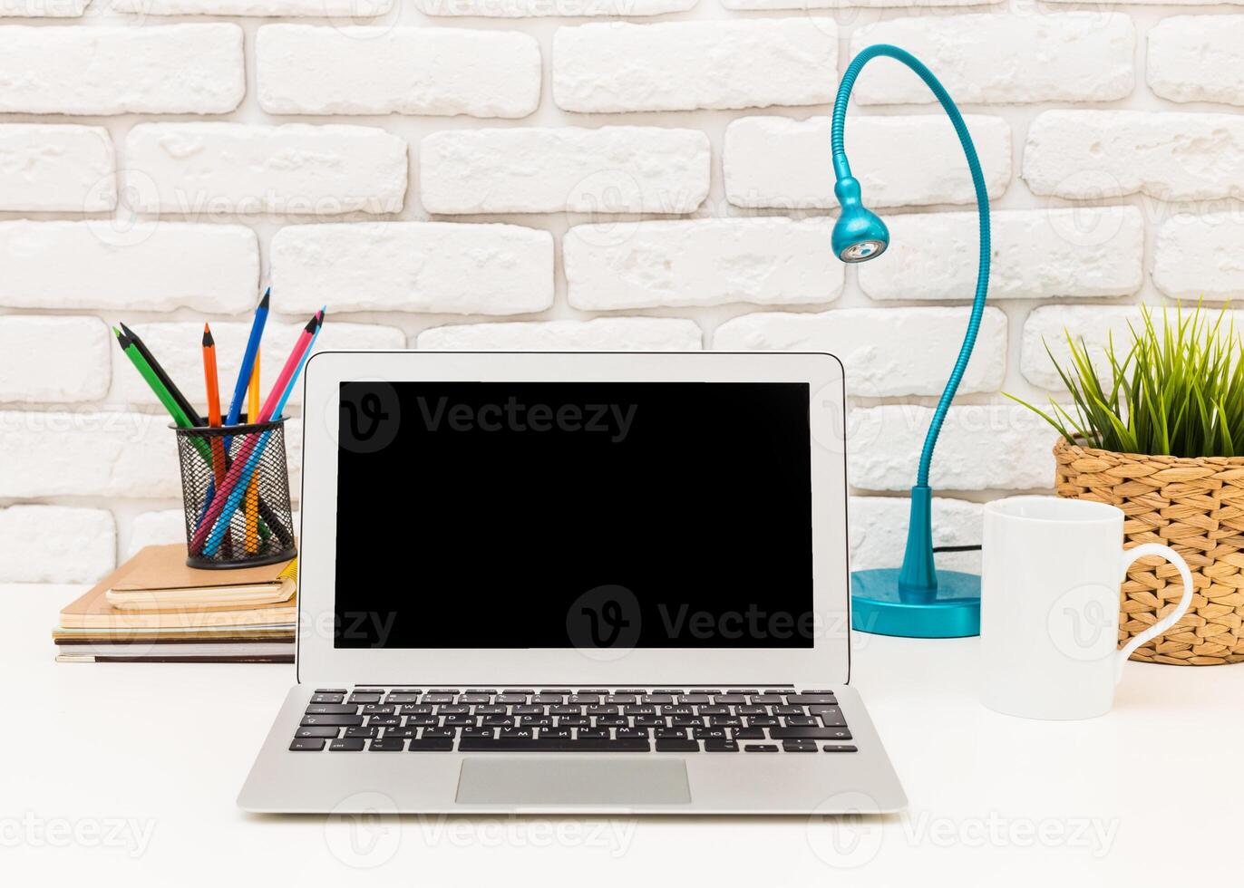 Modern workspace setup with laptop, stationery, and decorative elements, perfect for productivity photo