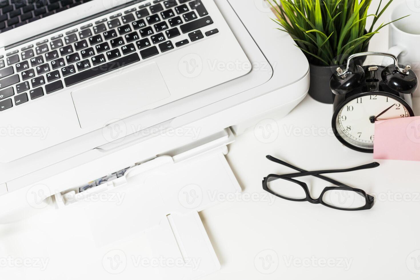 Workspace with laptop and printer displaying organized office essentials in a bright and tidy environment photo