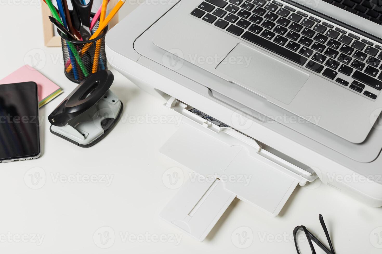 Workstation setup with laptop, printer, and office supplies for efficient productivity photo