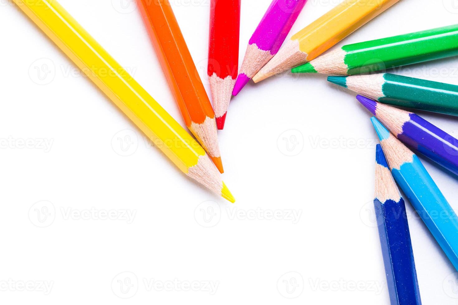 Colorful assortment of colored pencils arranged in a circular pattern on a white surface for creative art projects photo