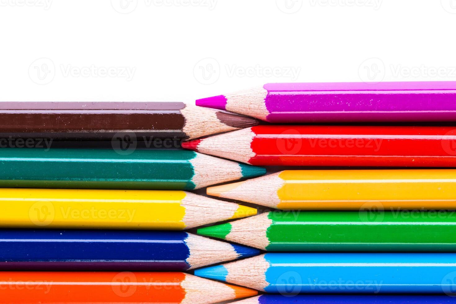 Vibrant colored pencils arranged neatly in a creative display on a white background photo