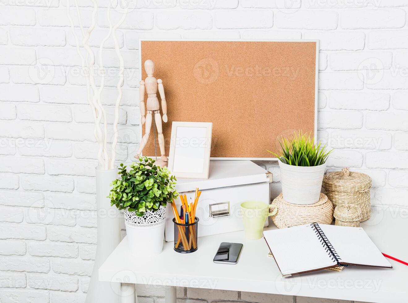 Workspace arrangement with decorative elements and organizational tools on a bright desk photo