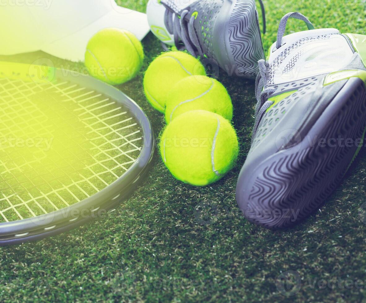 Tennis equipment and balls on a grassy court during daytime practice session photo