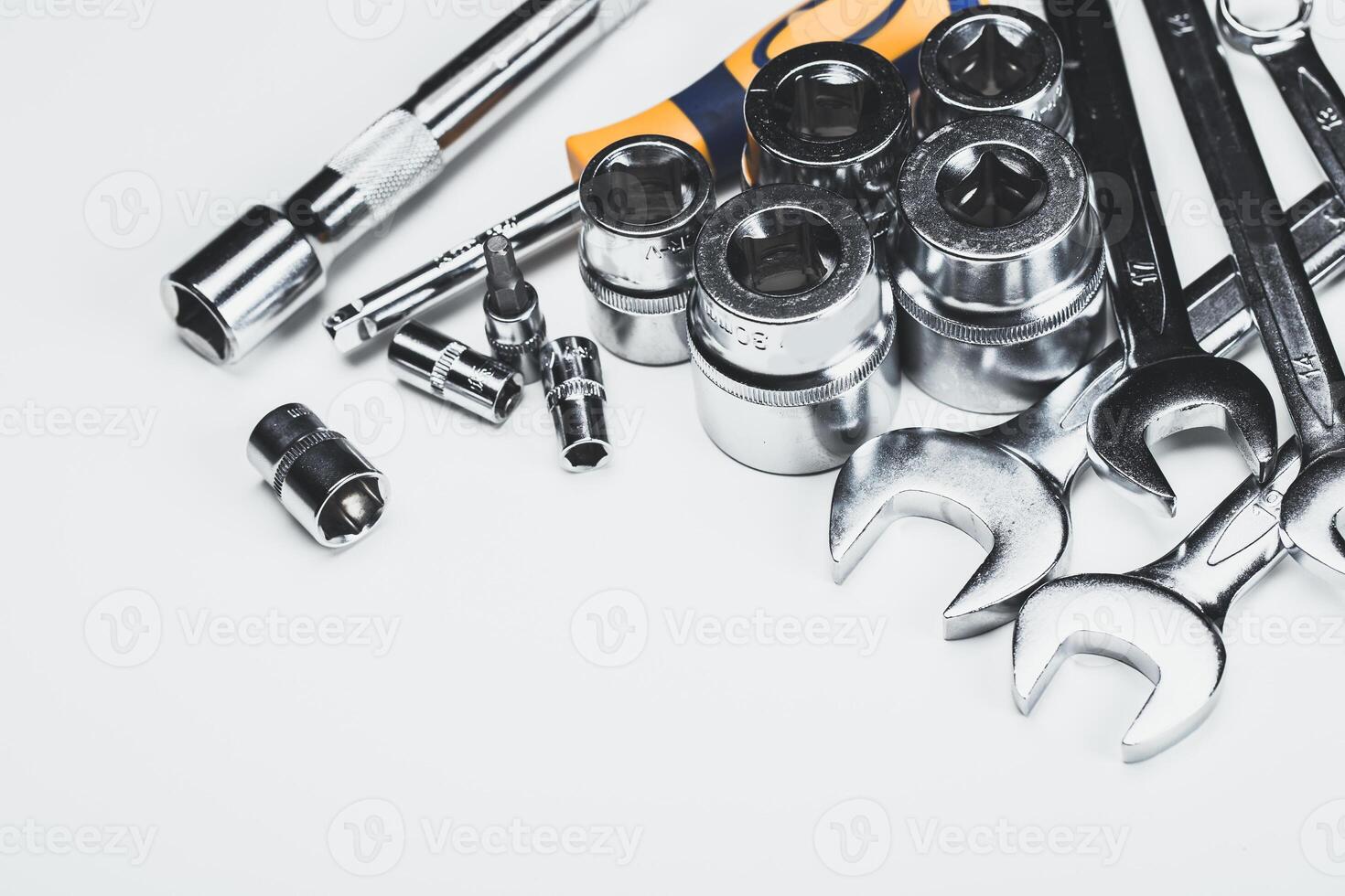Collection of various hand tools and sockets neatly arranged on a white background for mechanics or DIY projects photo