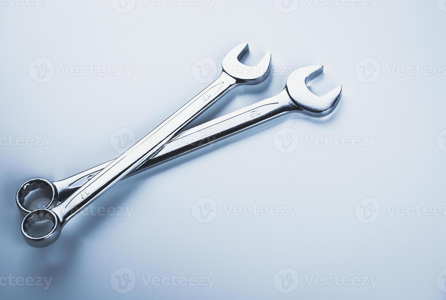 Wrenches laid on a white background ready for mechanical maintenance and repairs in a workshop environment photo