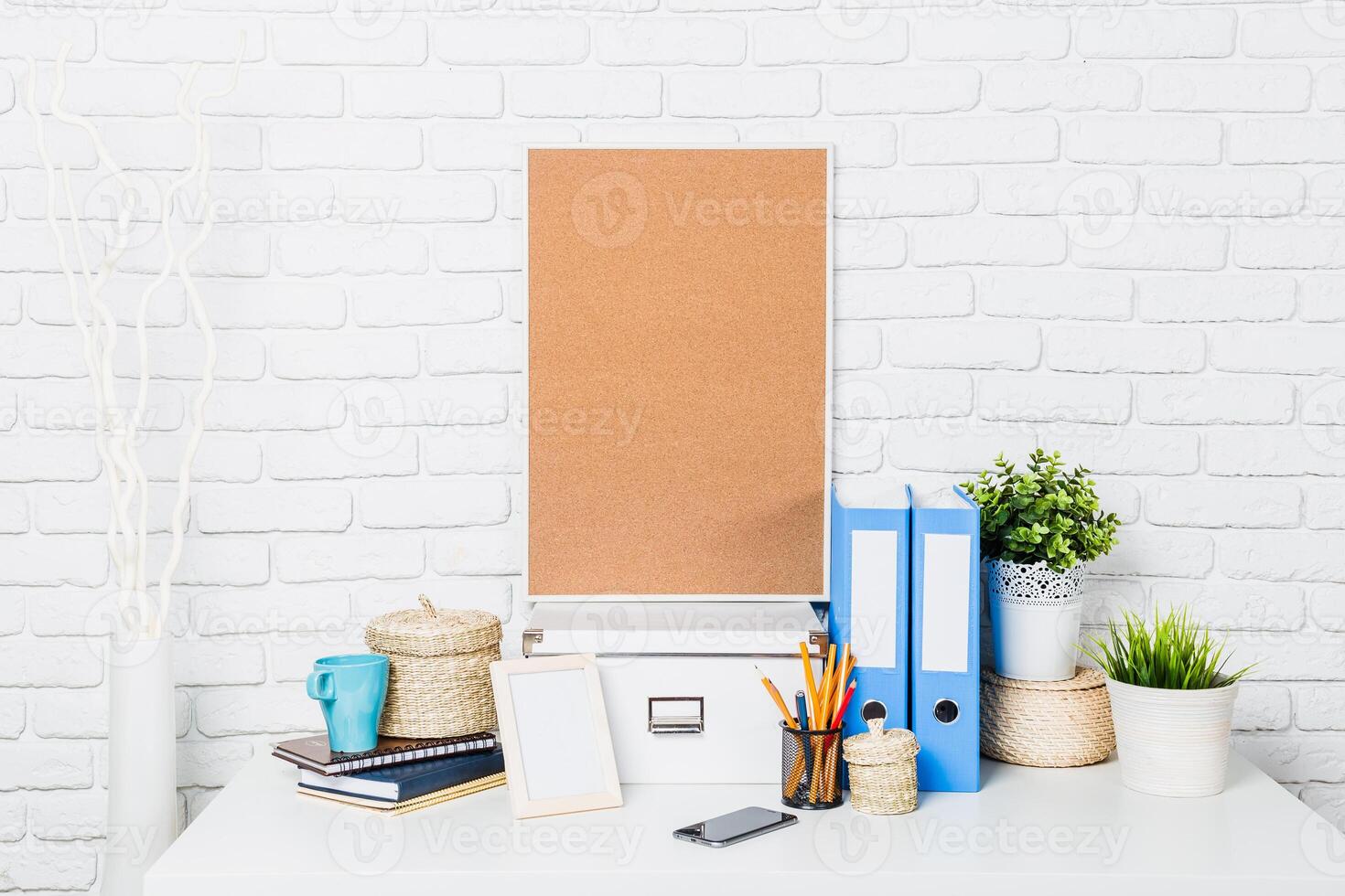 Minimalist workspace setup with organizational tools and decorative plants in a bright environment photo