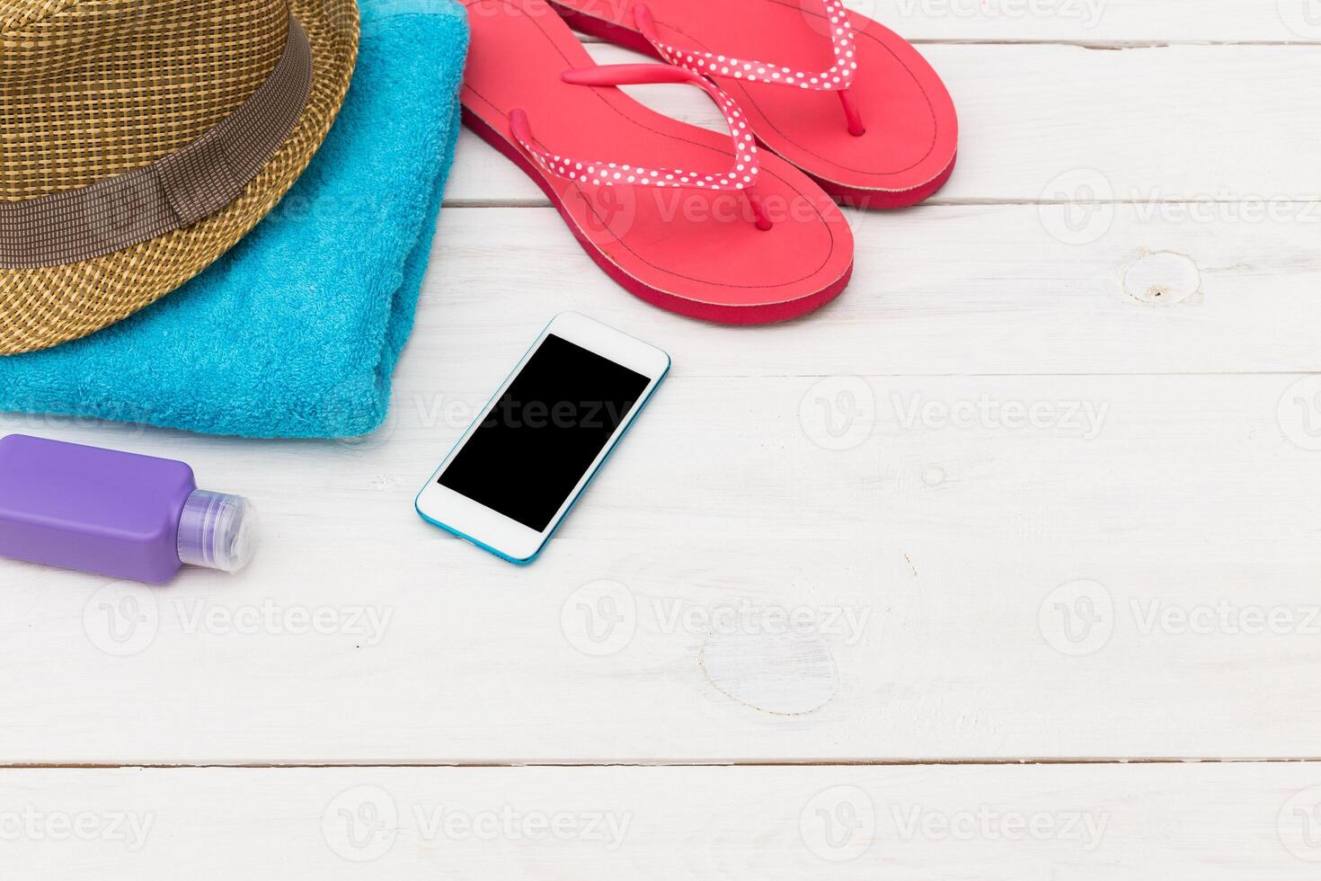 Relaxing by the beach with essentials like a hat, towel, and sandals ready for a sunny day photo
