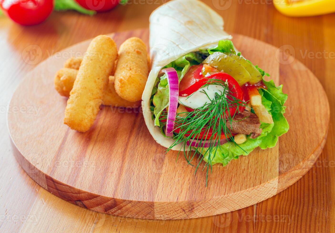 Delicious double cheeseburger on a wooden cutting board with fresh vegetables at a casual dining setting photo