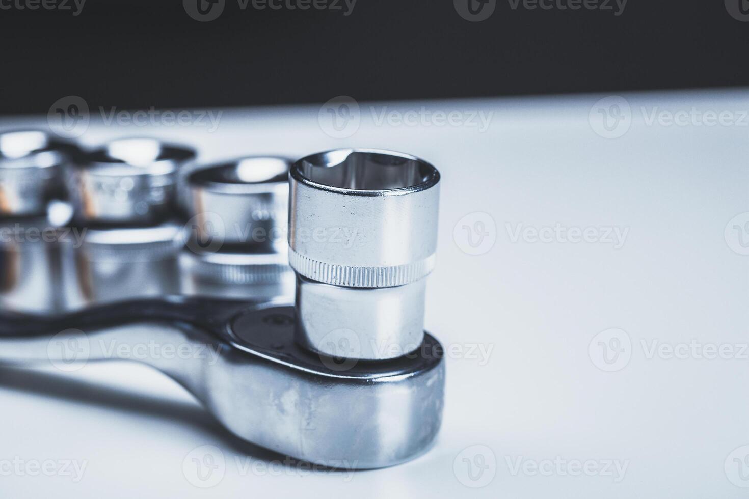 High-quality socket wrench set displayed on a workbench with focus on a socket attachment photo