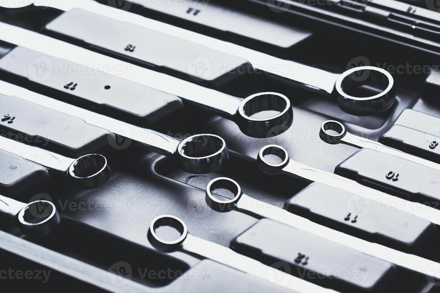 Collection of chrome wrenches organized in a tool case ready for use during a mechanical project in a workshop photo