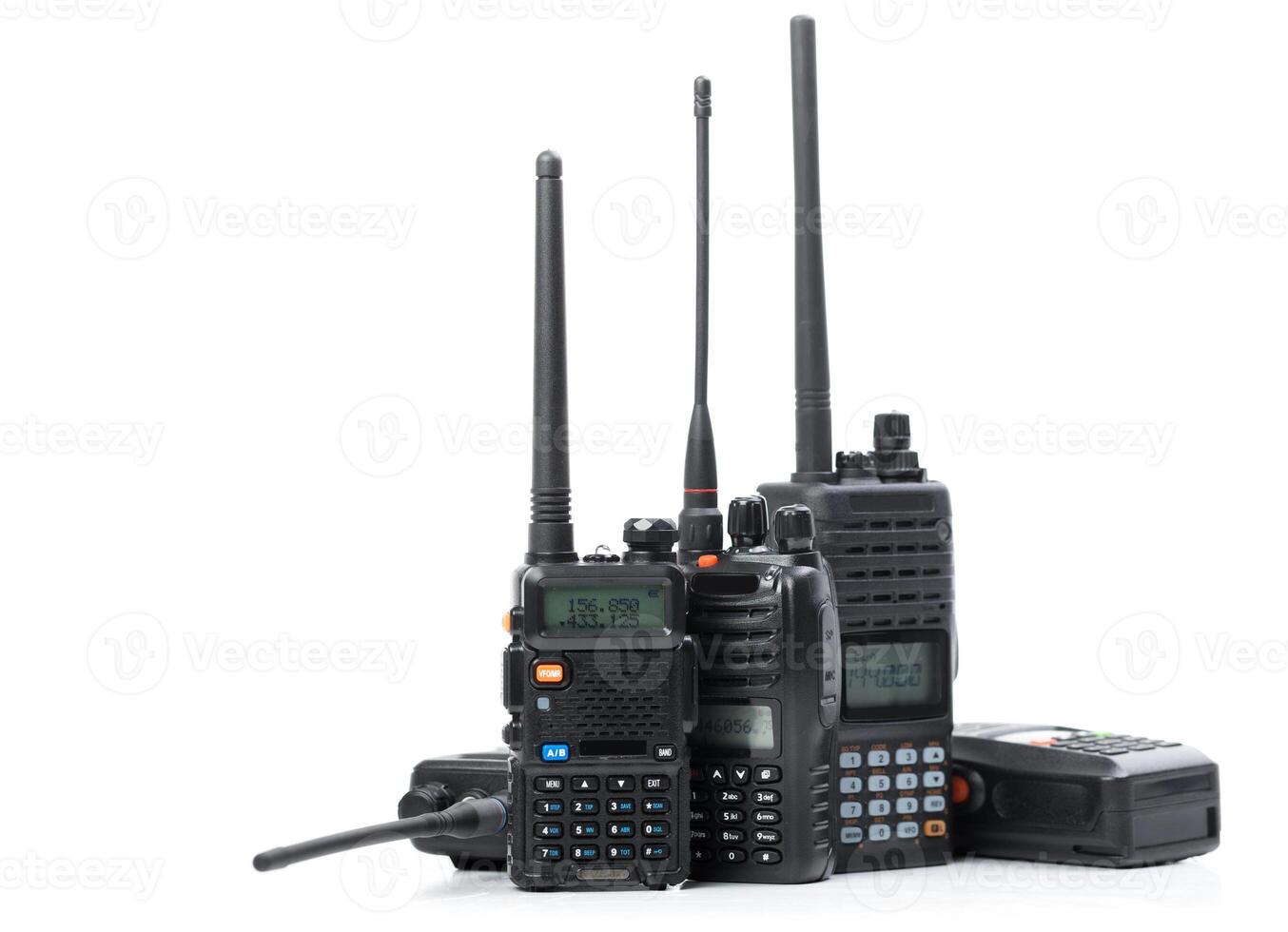 Variety of handheld radio communication devices arranged on a white background showcasing different models and sizes photo