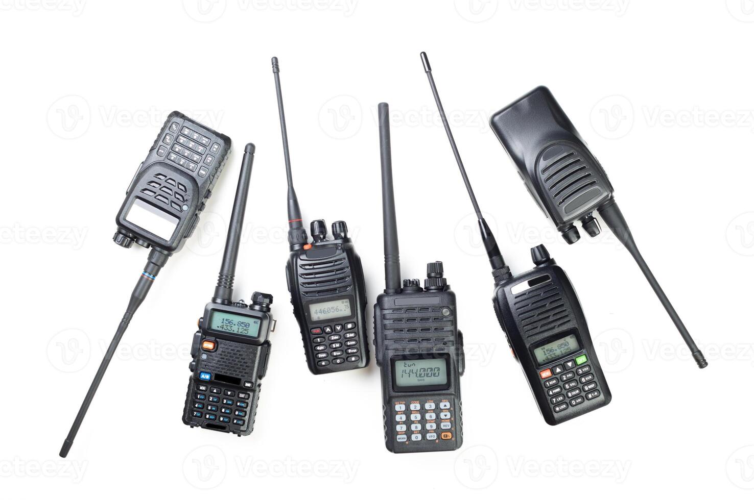 Multiple handheld radios arranged on a white background showcasing various designs and features for communication purposes photo