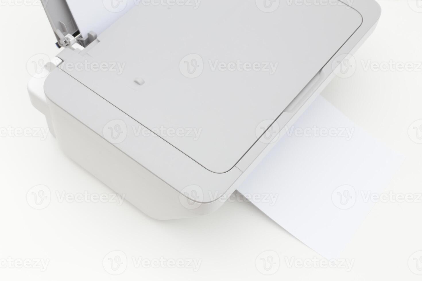 Printer in use at an office during the morning printing documents and sheets of paper photo