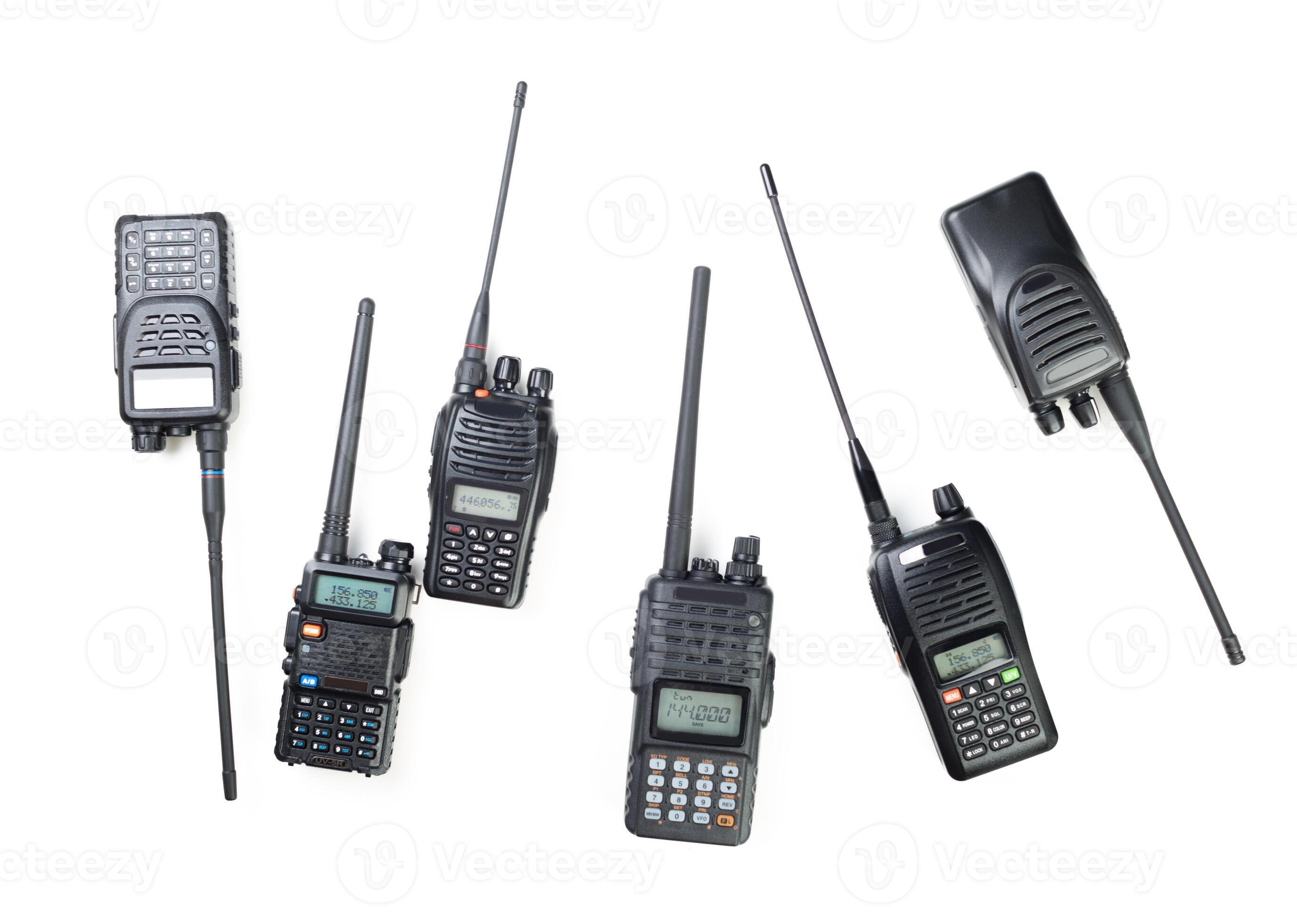 Variety of handheld two-way radios displayed on a white surface for ...