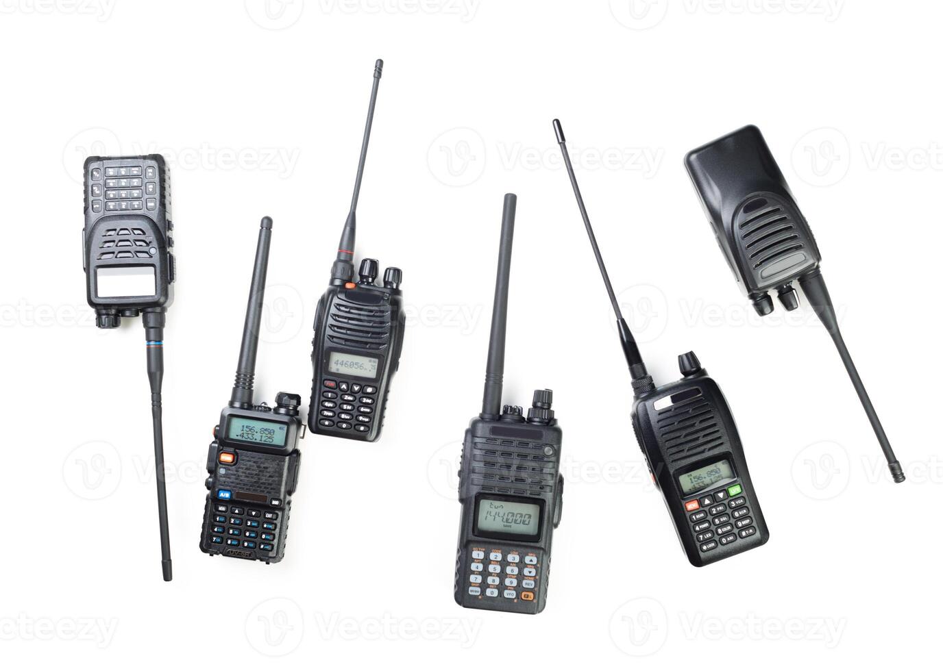 Variety of handheld two-way radios displayed on a white surface for communication needs photo