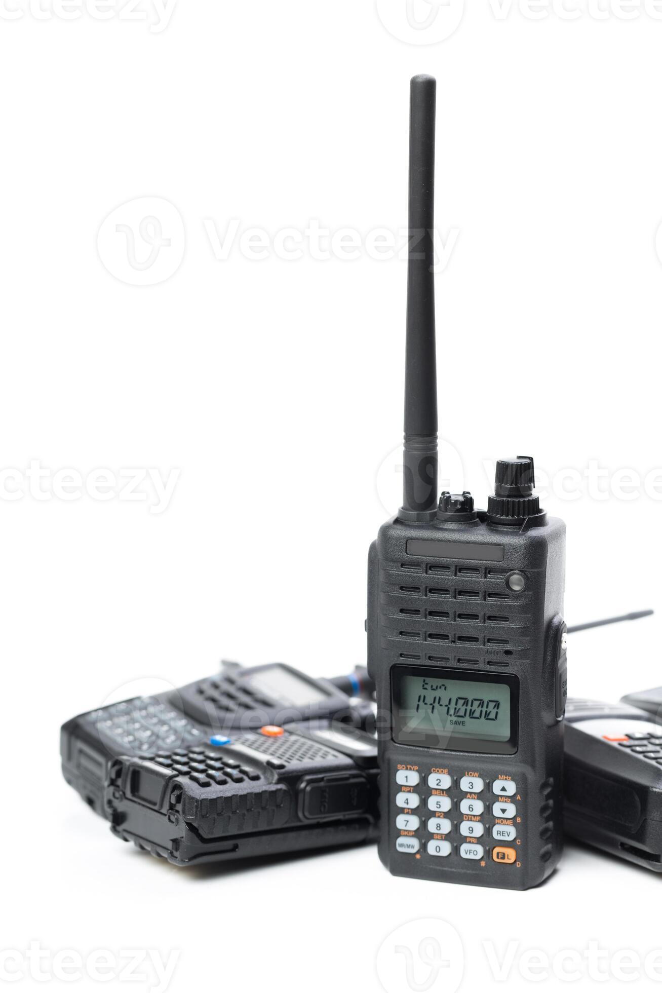 Multiple handheld radios stacked together with a prominent display unit ...