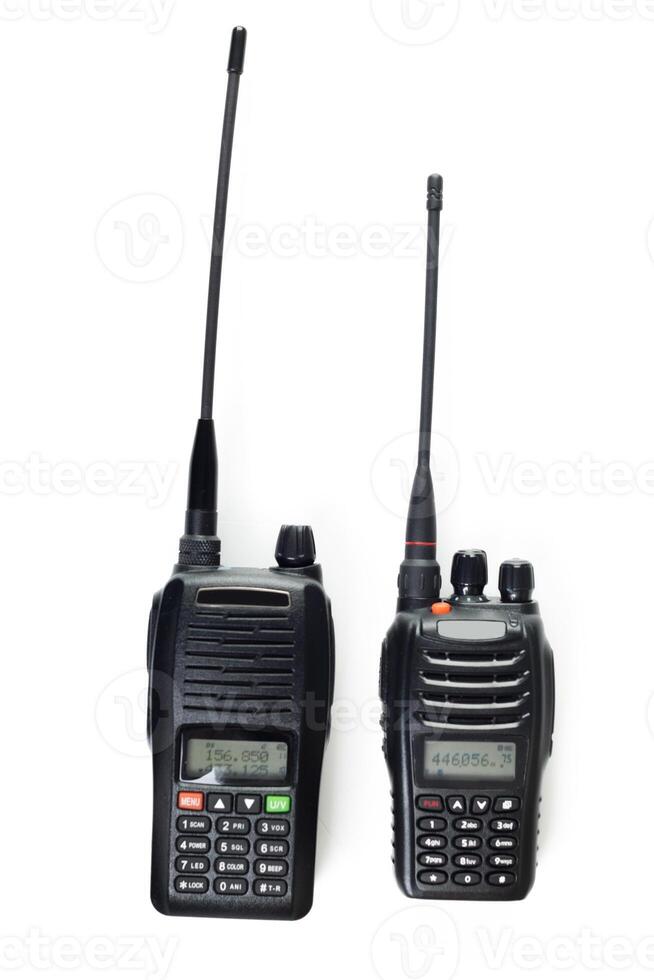 Two black handheld radios for communication with antennas displayed on a white background photo