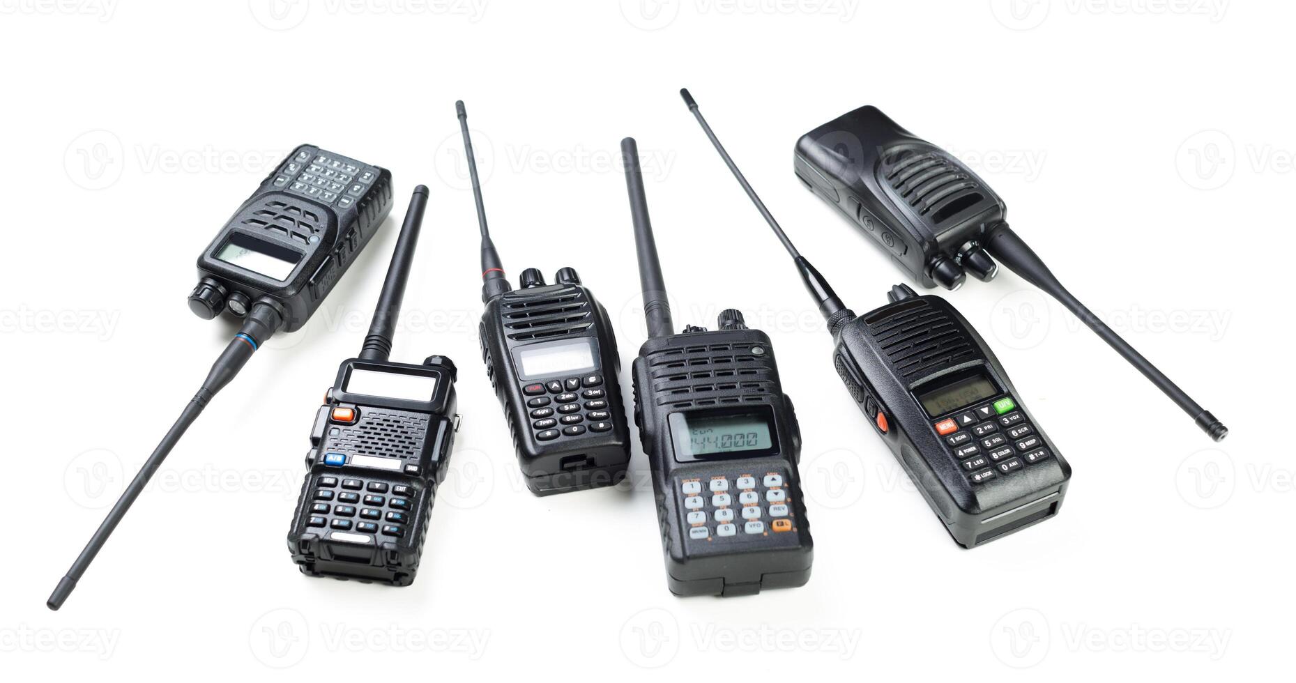 Various handheld radios displayed on a white background for communication and signaling purposes photo
