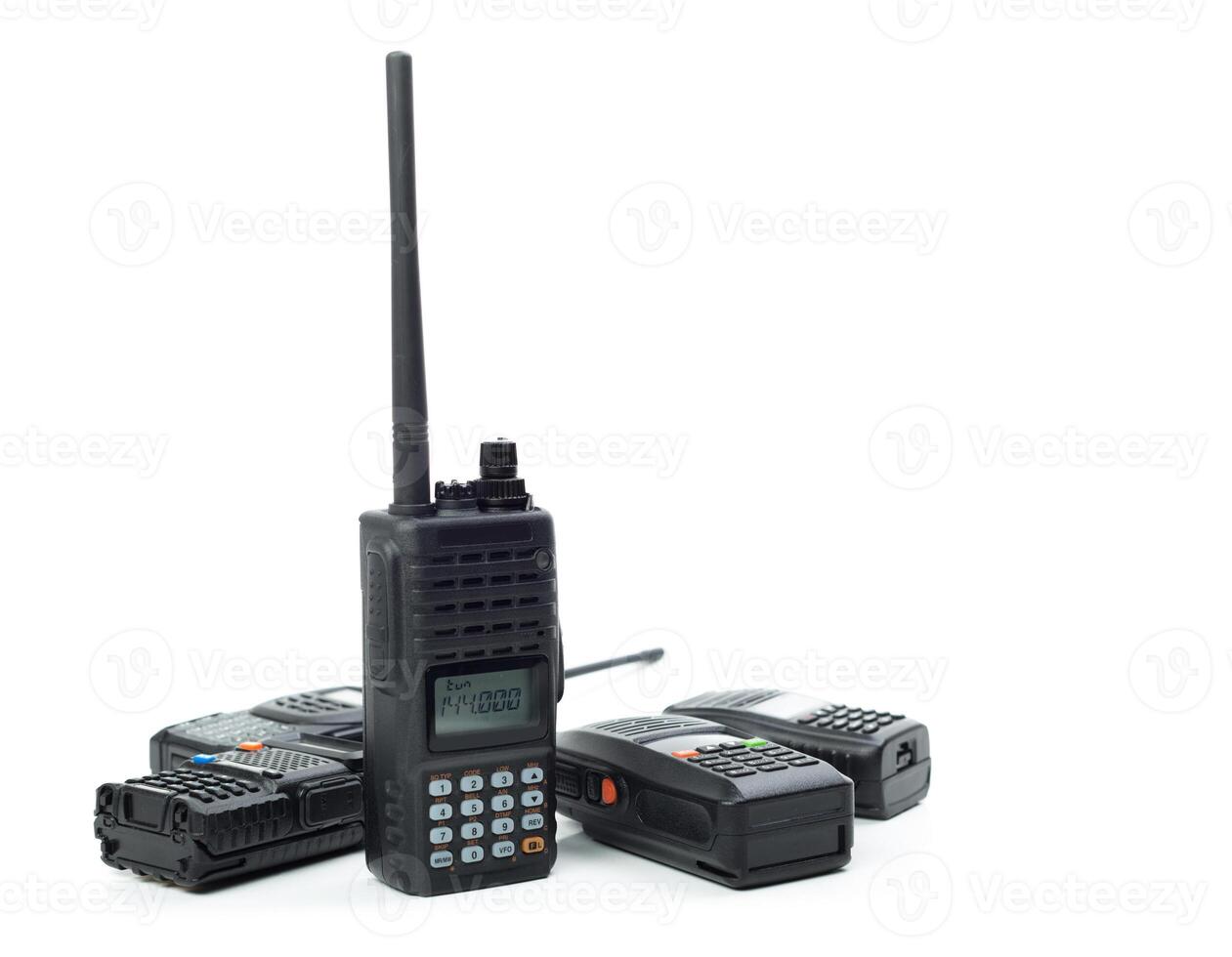 Collection of handheld radios arranged on a white background showcasing communication technology photo