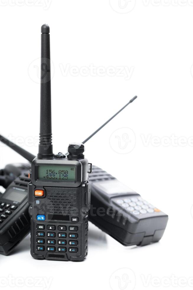 Various two-way radios on a white background ready for communication in outdoor activities or emergencies photo