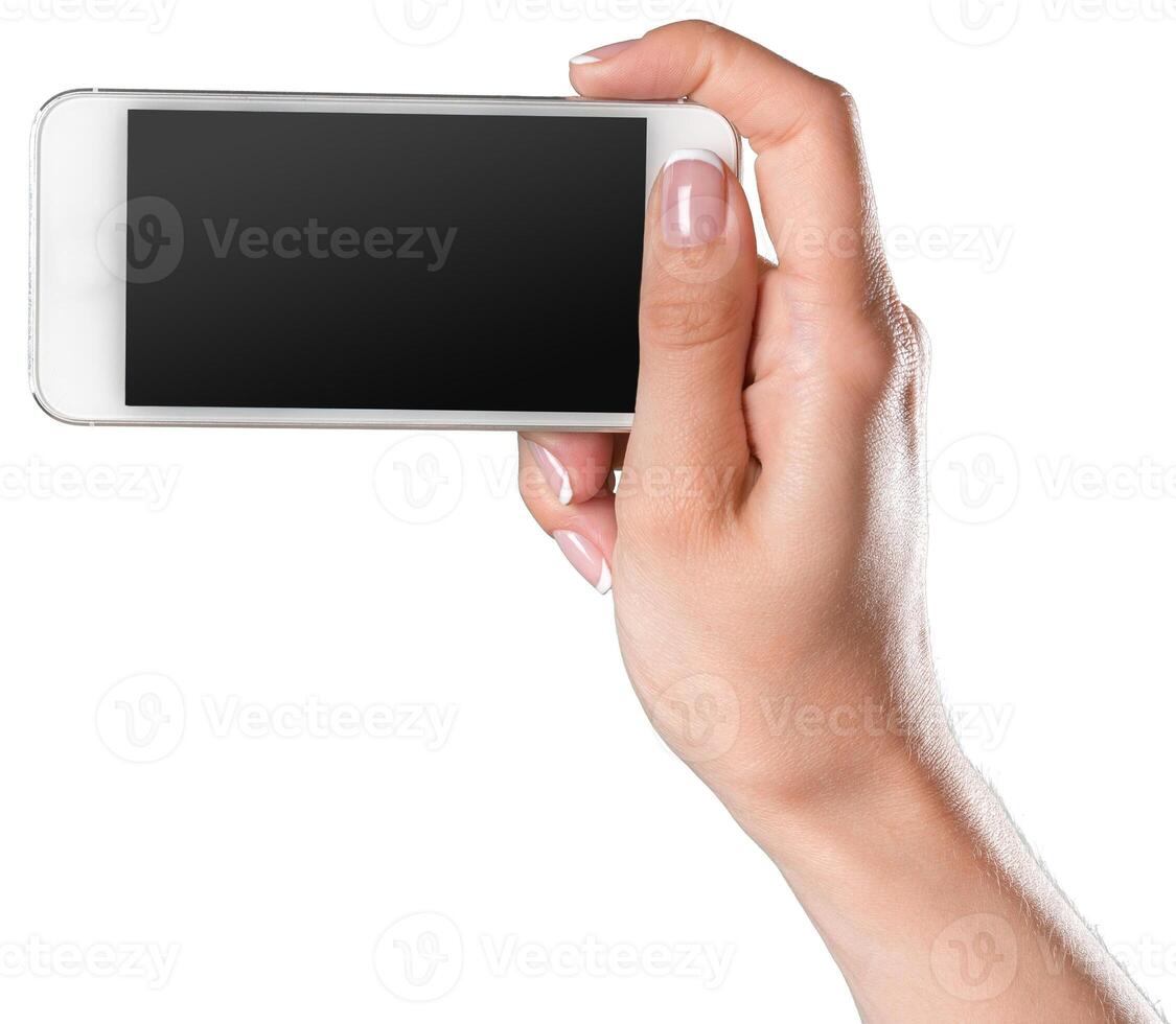 Hand holding a smartphone ready for taking a picture in bright lighting conditions indoors photo