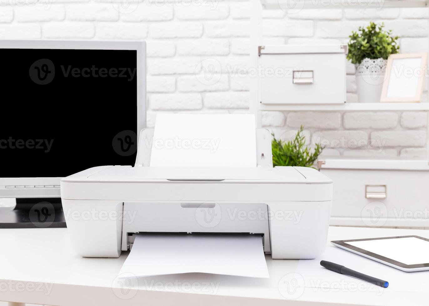 Printer in a modern workspace printing documents on a clean desk with a computer and stationery photo