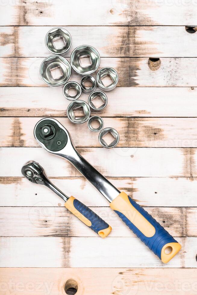 Tools for mechanical work organized on wooden table ready for use in a garage or workshop setting photo