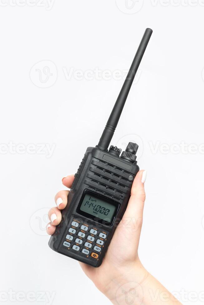 Handheld communication device held by a person with long nails in a bright environment photo