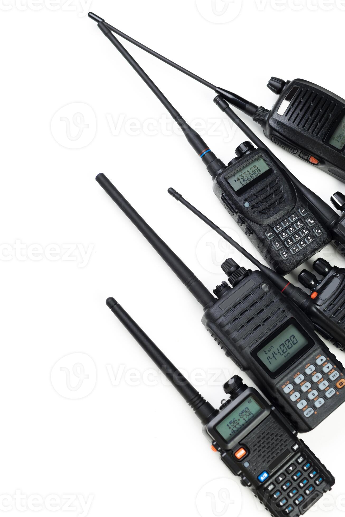 Multiple handheld radios arranged in a row displaying various features ...