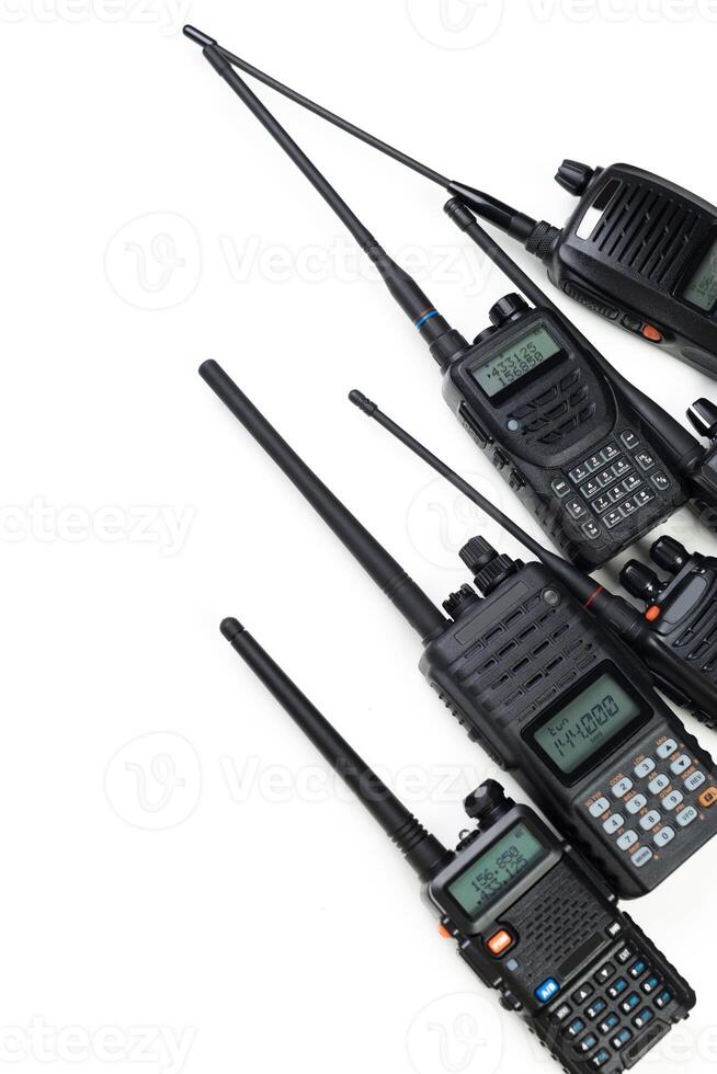 Multiple handheld radios arranged in a row displaying various features and designs for communication photo
