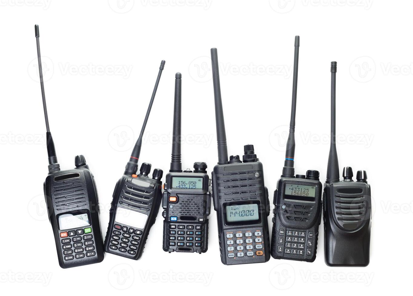 Collection of various handheld two-way radios displayed for communication technology enthusiasts photo