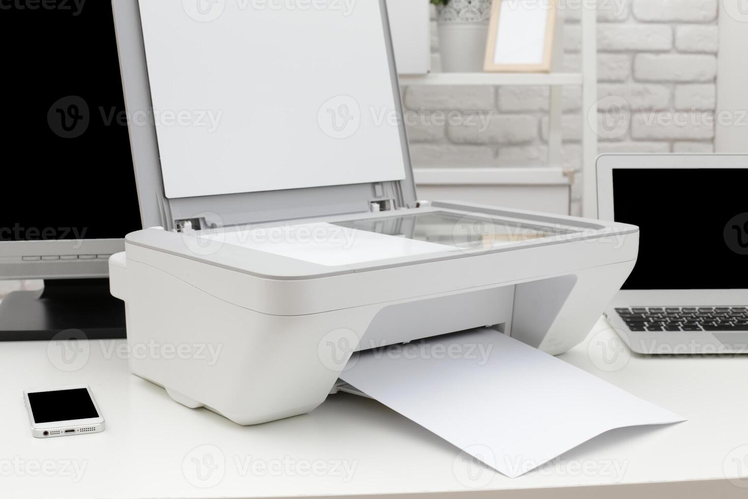 Home office setup with a printer scanning documents during a busy workday photo