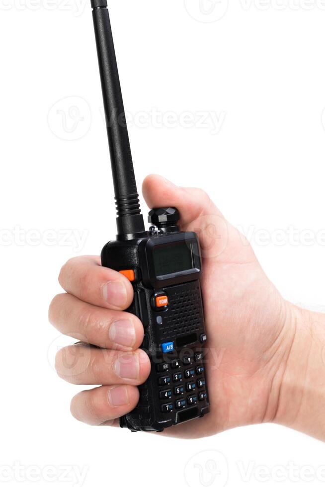 Modern handheld walkie-talkie device held in hand during outdoor activities, suitable for communication in various environments photo