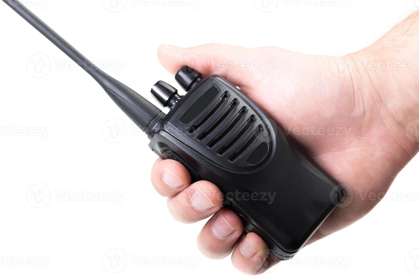 Handheld radio being operated, emphasizing communication in an outdoor setting photo