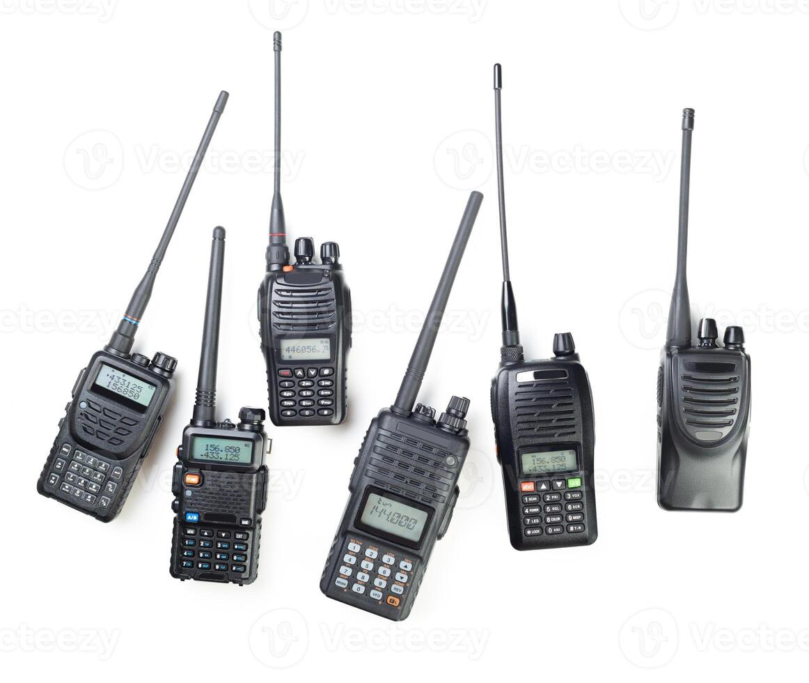 Collection of various walkie-talkies arranged on a white background showcasing communication devices in detail photo
