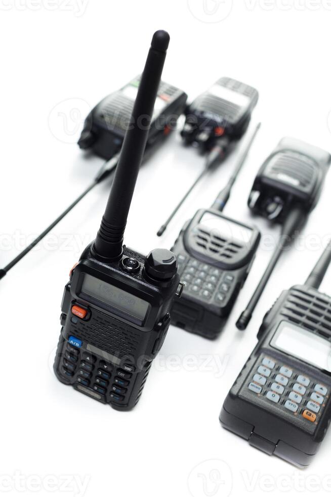 Various handheld radios arranged on a white background showcasing communication devices for diverse applications photo