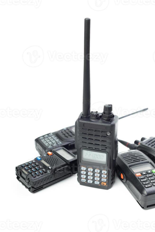 Collection of portable two-way radios arranged on a white background ready for use in communication and signaling photo