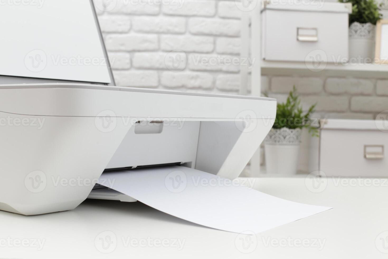Modern printer in a bright office environment with paper being printed and greenery in the background photo