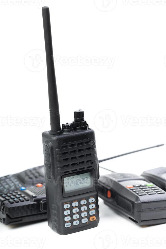 Two walkie talkies and a radio with antenna in a close-up display on a white background showcasing communication tools photo