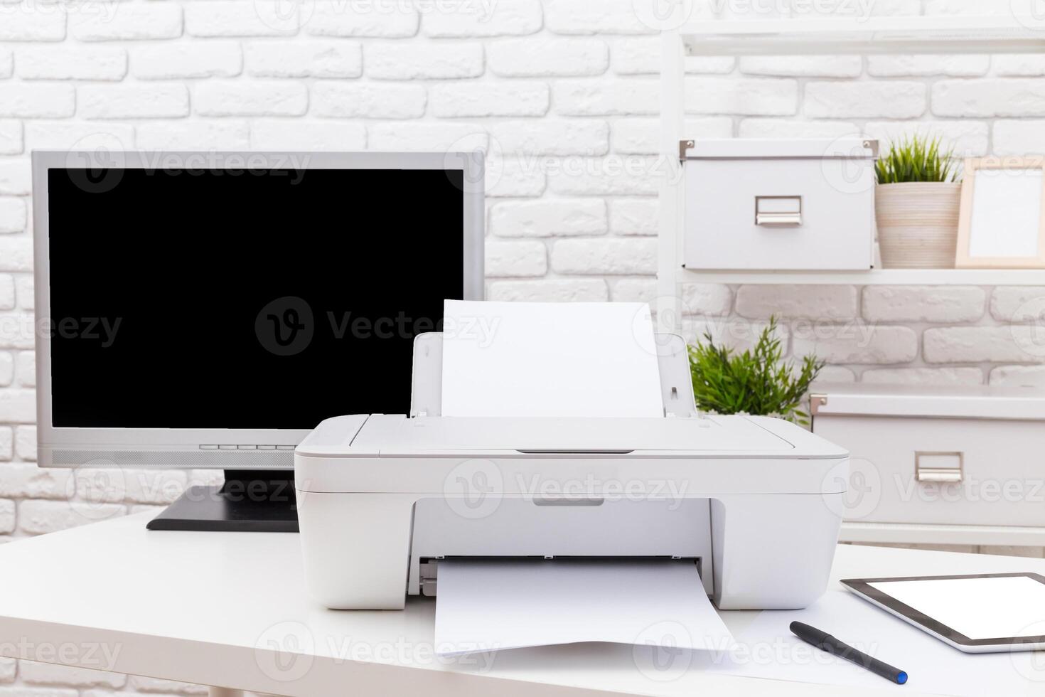 Home office setup with a printer, computer monitor, and organization essentials on a modern desk photo